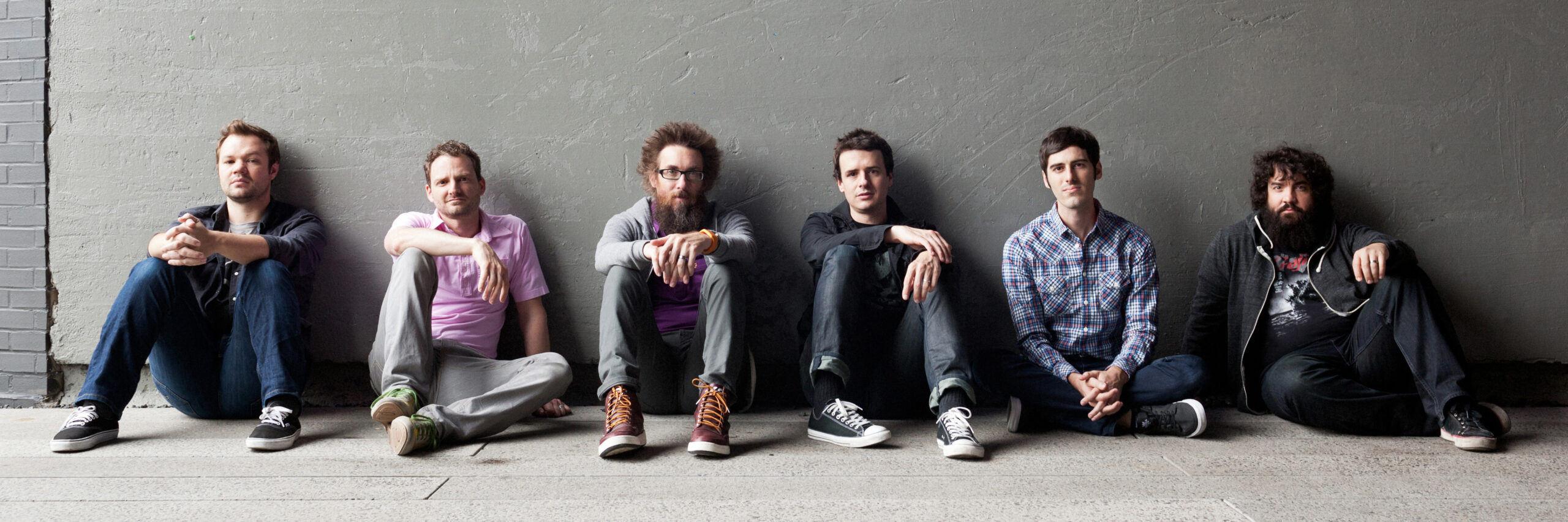 Group of man sitting on the floor