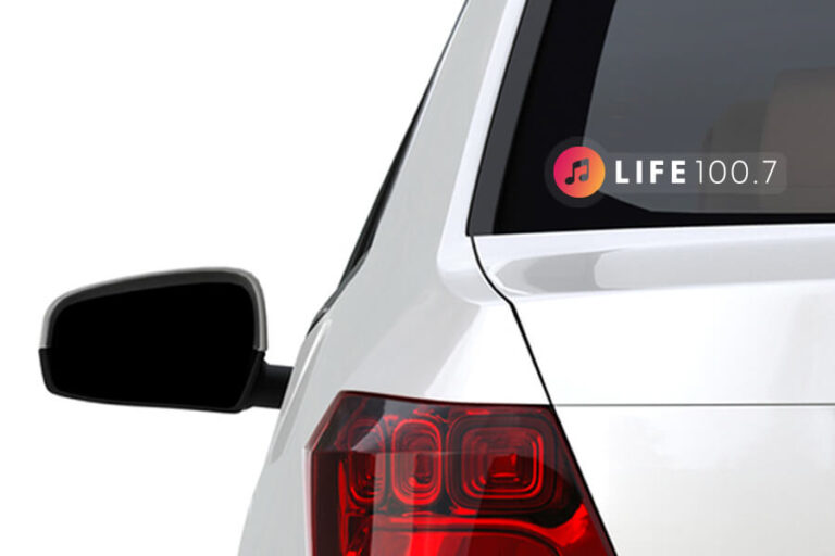 The rear of the car with a Life 100.7 sticker