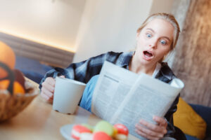 An amazed teen girl looking at a paper