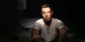 Jermey Camp in a dark room with light shining partly on his face